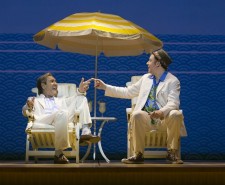 Robert Lindsay and Rufus Hound in Dirty Rotten Scoundrels - on beach chairs beneath a yellow umbrella