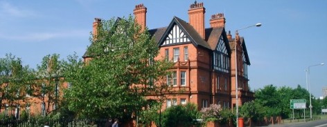 Red brick exterior of the Working Class Movement Library, fronted by trees