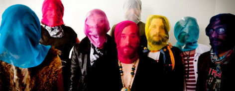Band members of of Montreal with coloured bags over their heads.