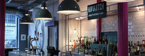 Photo of the long bar in Hopskotch with hanging lights
