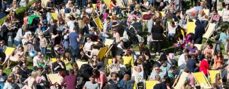 Photograph of people on deckchairs in the sunshine