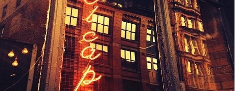 Photo of El Capo's neon sign in a window