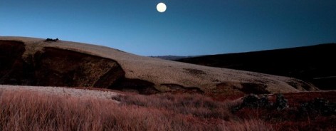 Photo of Howarth moor at night, with a full moon above it