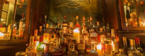 Photo of the speakeasy bar in cane and grain with spirit bottles lined up