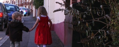 Photo of a boy and girl hand in hand.