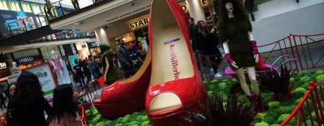 Photo of Frog Flowers' Dig the City installation at the Arndale Centre, with an enormous pair of red shoes
