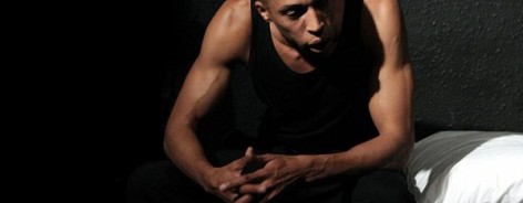 Photo of the actor playing Len Johnson, sat with his hands on one knee