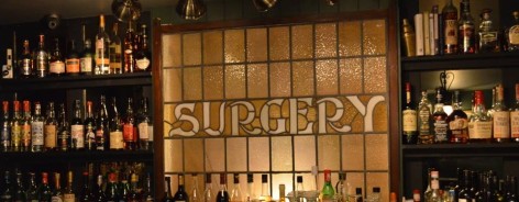 Photo of a stained glass window showing the word 'Surgery'