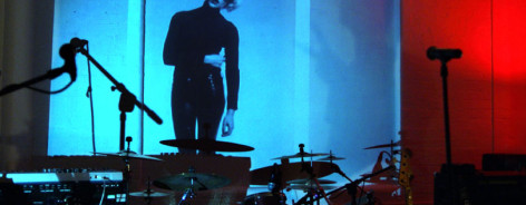Photo of Kraak's event space with a coloured screen and drum kit