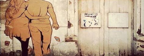 Photo of a piece of Sneak's street art, showing a couple walking away, dropping their mobile phones