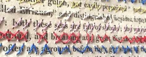 Photo of a page form a book cross stitched through so that you can barely read the words