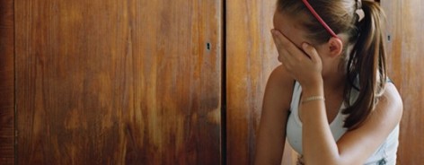 Photo of Milena, turned half away from the camera and hiding her face