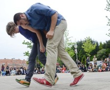 Photo of two dancers bent forwards in the same position
