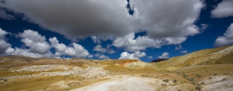 Photo of a yellowand great landscape with great clouds in a blue sky