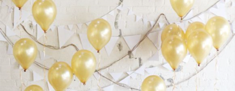Photo of gold balloons on a white wall