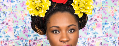 Photo of a woman with yellow and red flowers in her hair