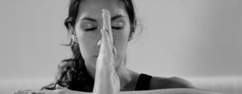 Black and white photo of a woman with her arms raised