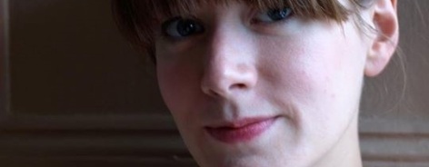 Head shot of Laura, wearing a turquoise necklace