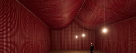 Photo of the red poppy cutouts in Cornelia Parker's War Room