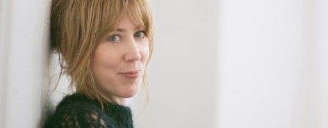 Photo of Beth against a white wall