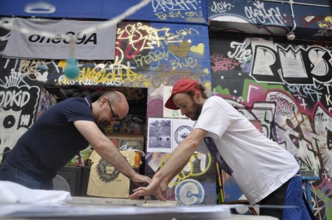 Photo of two men screenprinting