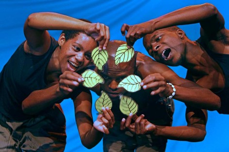 people hold up small green leaves