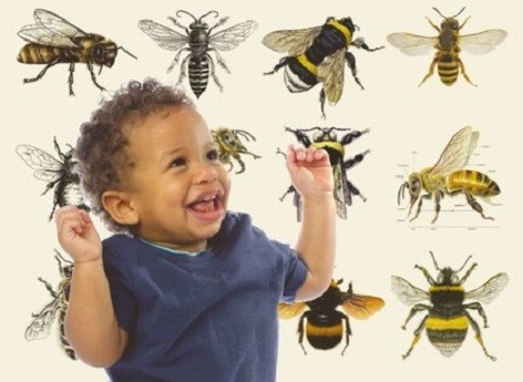 A baby with bee print in the background