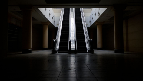 Two escalators lit starkly