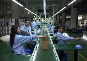 Factoryline workers producing artists Cohen van Balen's useless object.