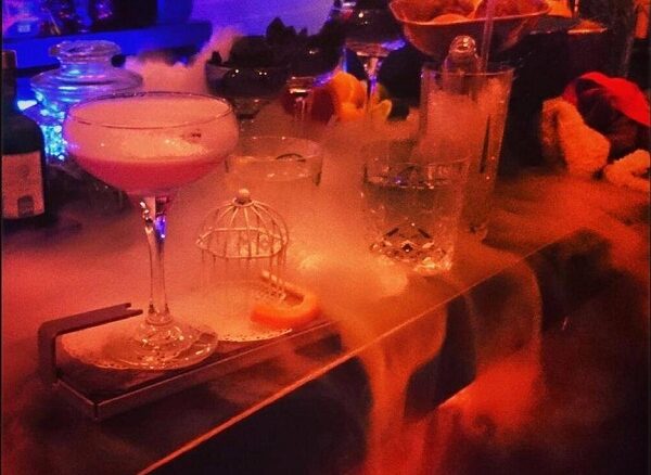 Dry ice smoking between cocktails on a bar.