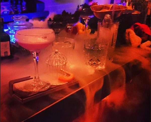 Dry ice smoking between cocktails on a bar.