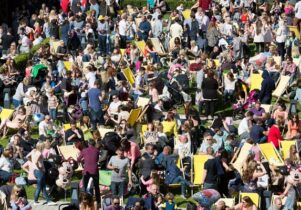 Photograph of people on deckchairs in the sunshine