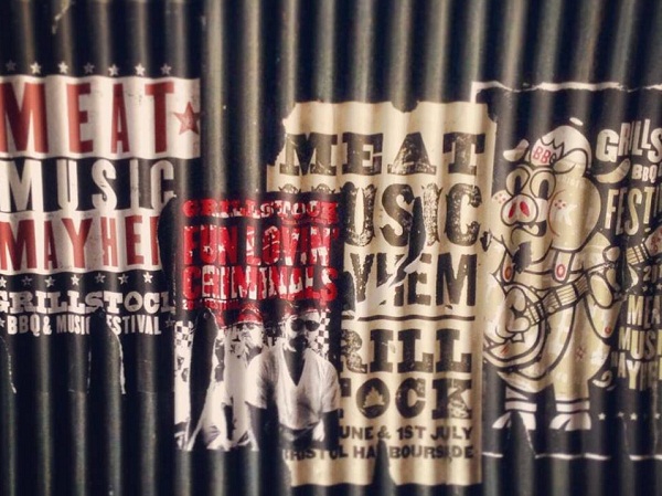 Posters on corrugated iron, advertising Grillstock.