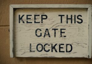 Photo of a sign that says 'Keep This Gate Locked'