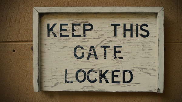 Photo of a sign that says 'Keep This Gate Locked'