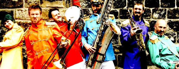 Colourful photo of a band in coloured jackets, holding their instruments