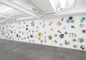 C++ by Ryan Gander, showing a wall of paint-splashed perspex palettes