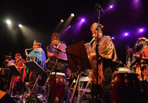 Photo of the Sun Ra Arkestra playing jazz in colourful outfits