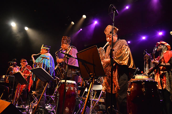 Photo of the Sun Ra Arkestra playing jazz in colourful outfits