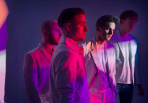 Pink and purple photo of band members from Wild Beasts