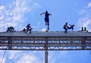 Shot from below of aerial dance performers on a hung stage