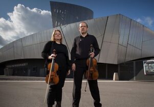 Photo of two musicians stood in front of IWM North