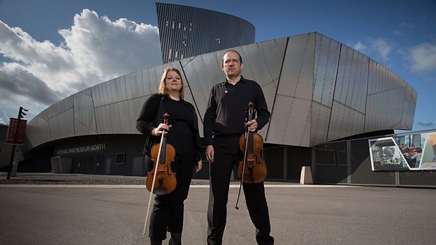 Photo of two musicians stood in front of IWM North
