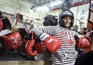Photo of a female Muslim boxer in red gloves