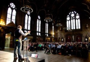 Photo of a speaker at the Design Manchester festival in the town hall