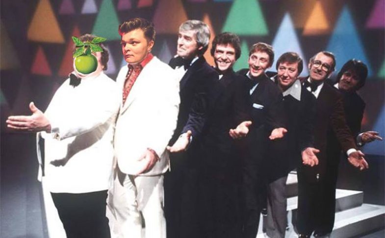 Photo of comedian Rob Pickford in a line of men in a while suit