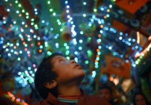A child looks up at bright lights