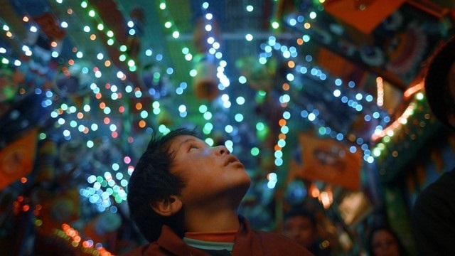 A child looks up at bright lights