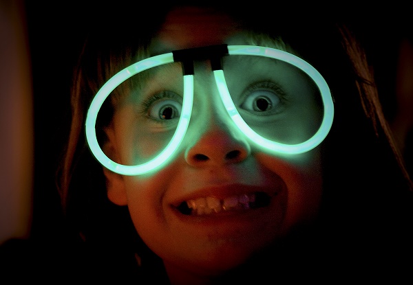 Photo of a kid wearing glow stick glasses