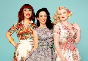 Phot0 of the 3 Puppini Sisters agains a teal background